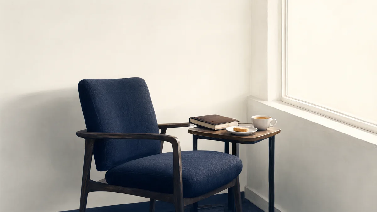 A journal, tea and snack beside a comfortable chair.