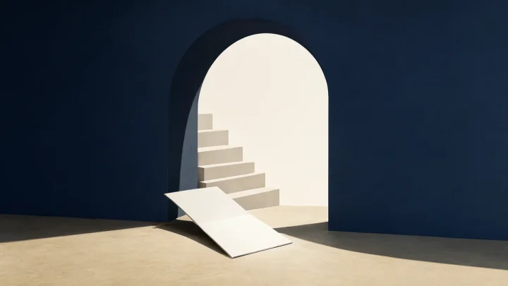An open navy architectural form beside folded paper steps and a blank research folio.