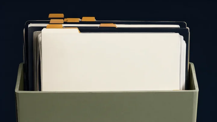 Distinct blank folders with colored tabs arranged in an accordion file.